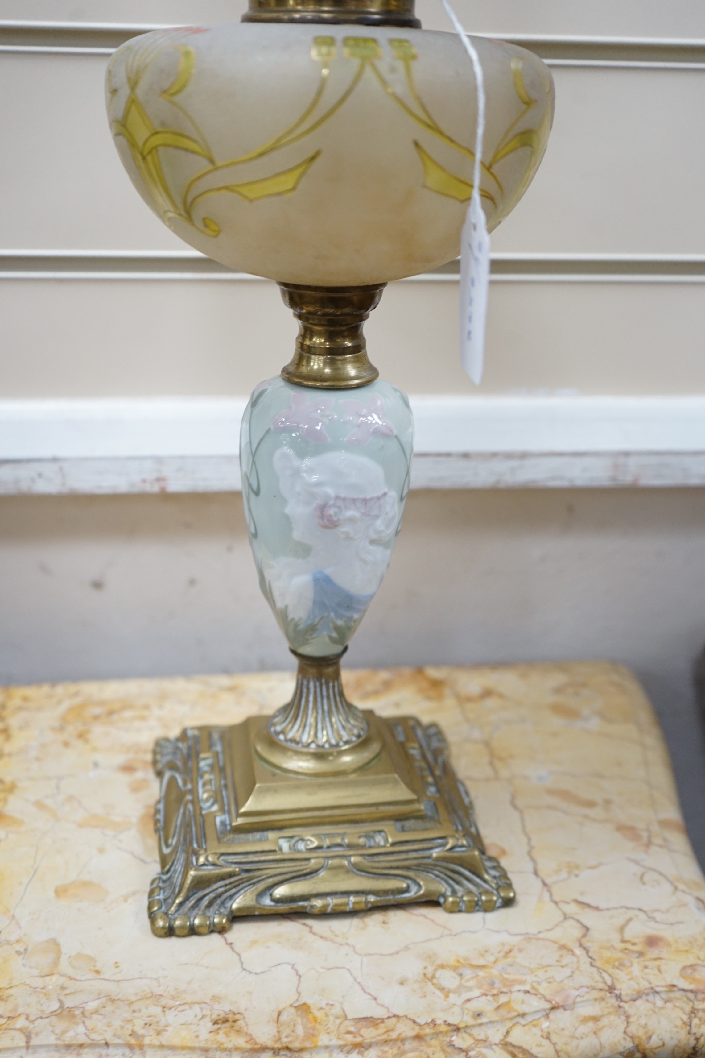 A pair of Art Nouveau decorative porcelain, brass and glass oil lamps. 64cm tall